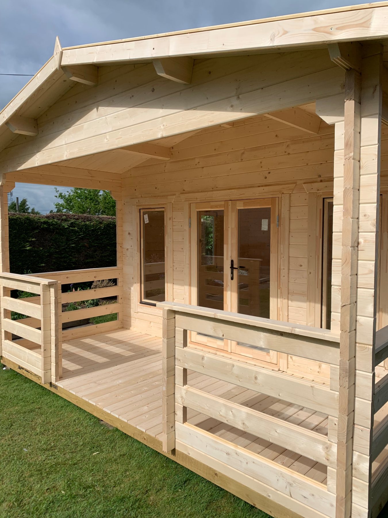 Natural timber log cabin with apex roof, covered porch, and double doors | Signature Garden Rooms, Central Scotland
