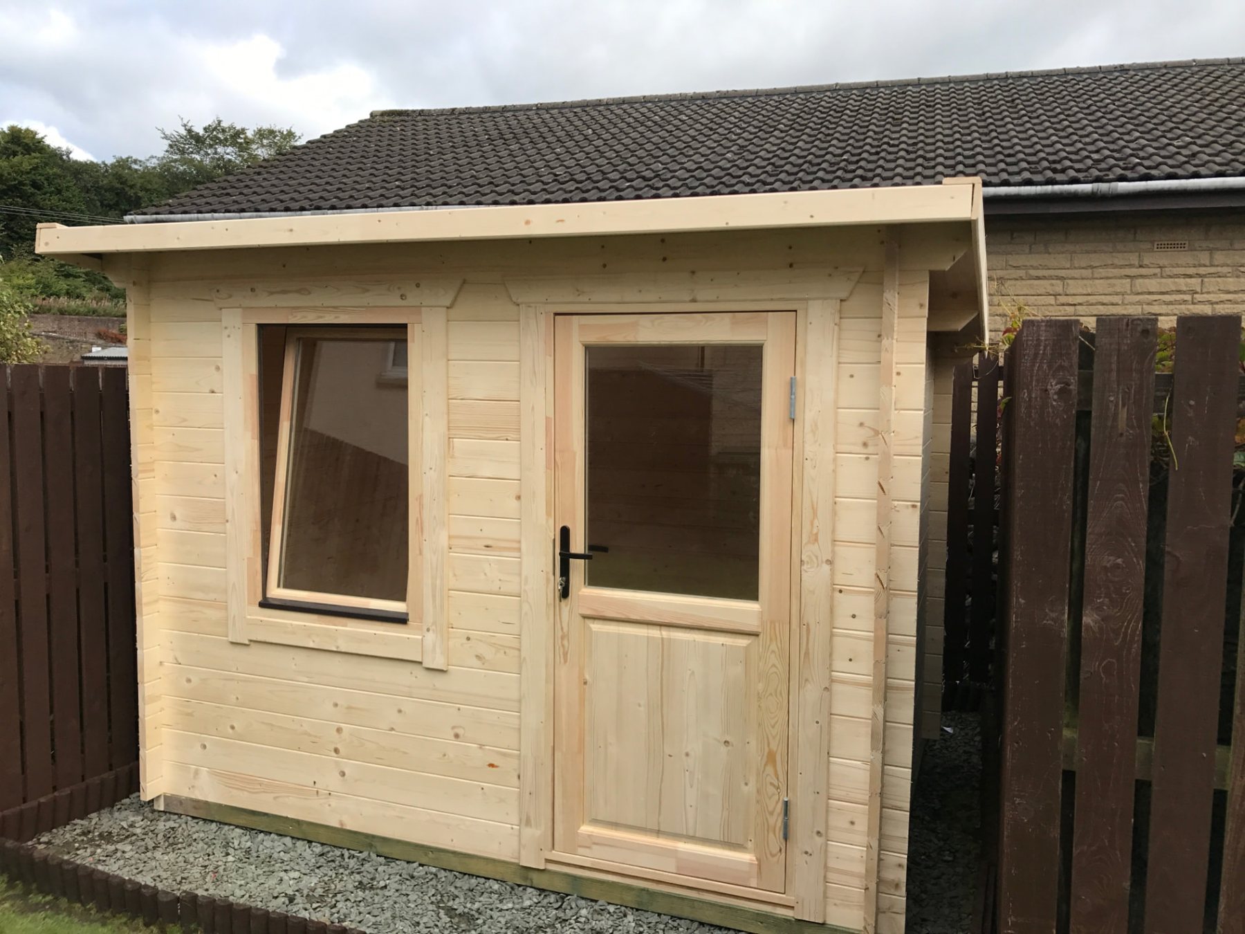 Untreated timber log cabin featuring single glass door and open tilt window | Signature Garden Rooms, Central Scotland