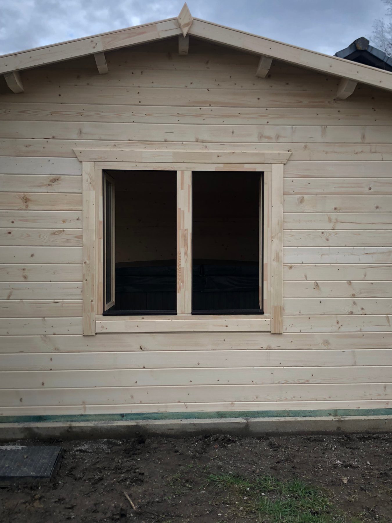 Exterior view of a timber log cabin featuring an open double glass window | Signature Garden Rooms, Central Scotland