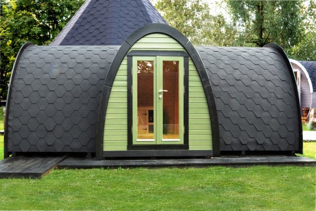 A curved green timber glamping pod with tiled roof and glass double doors | Signature Garden Rooms, Central Scotland