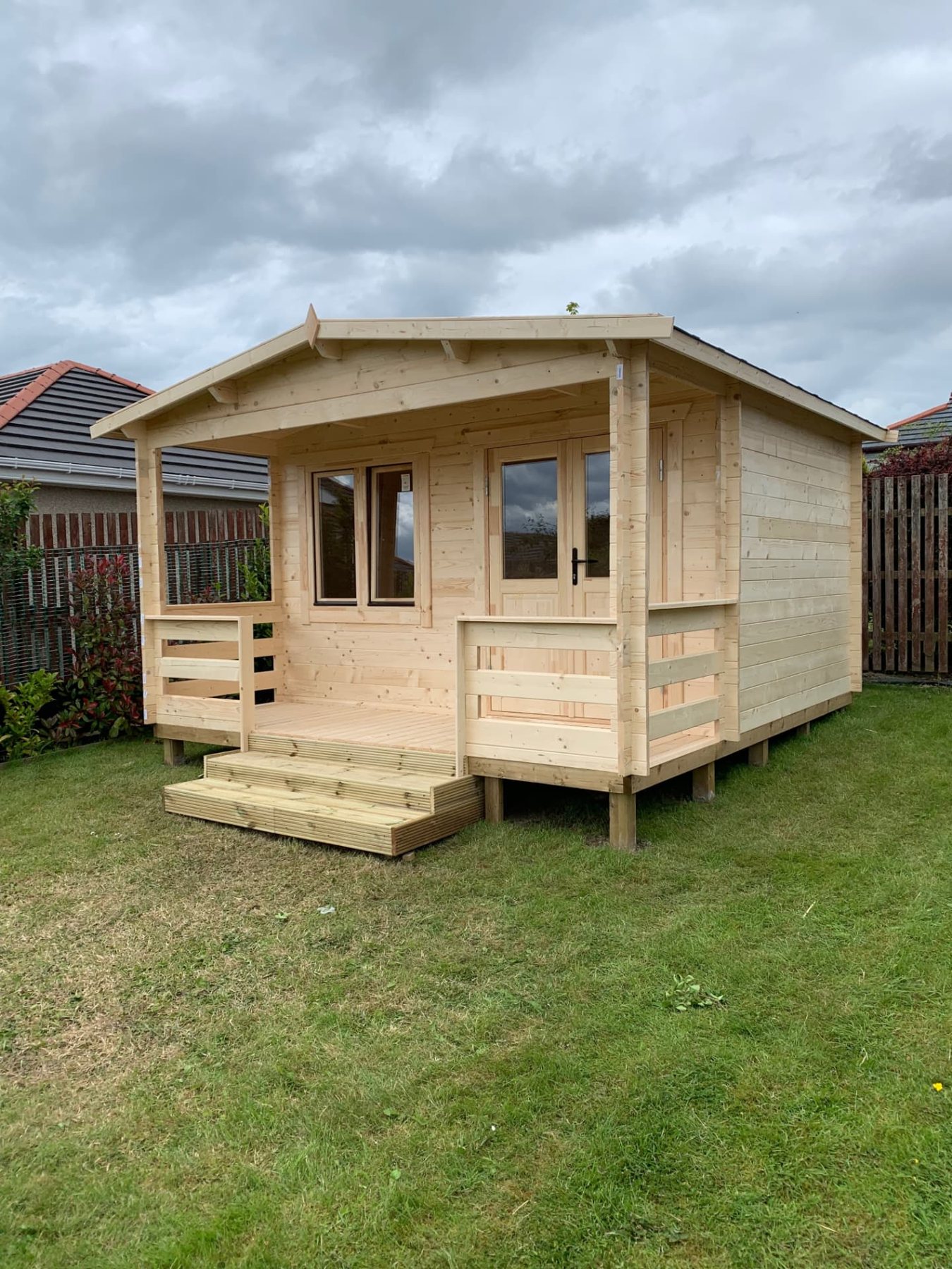 Natural timber log cabin featuring an apex roof, front veranda, and double doors | Signature Garden Rooms, Central Scotland