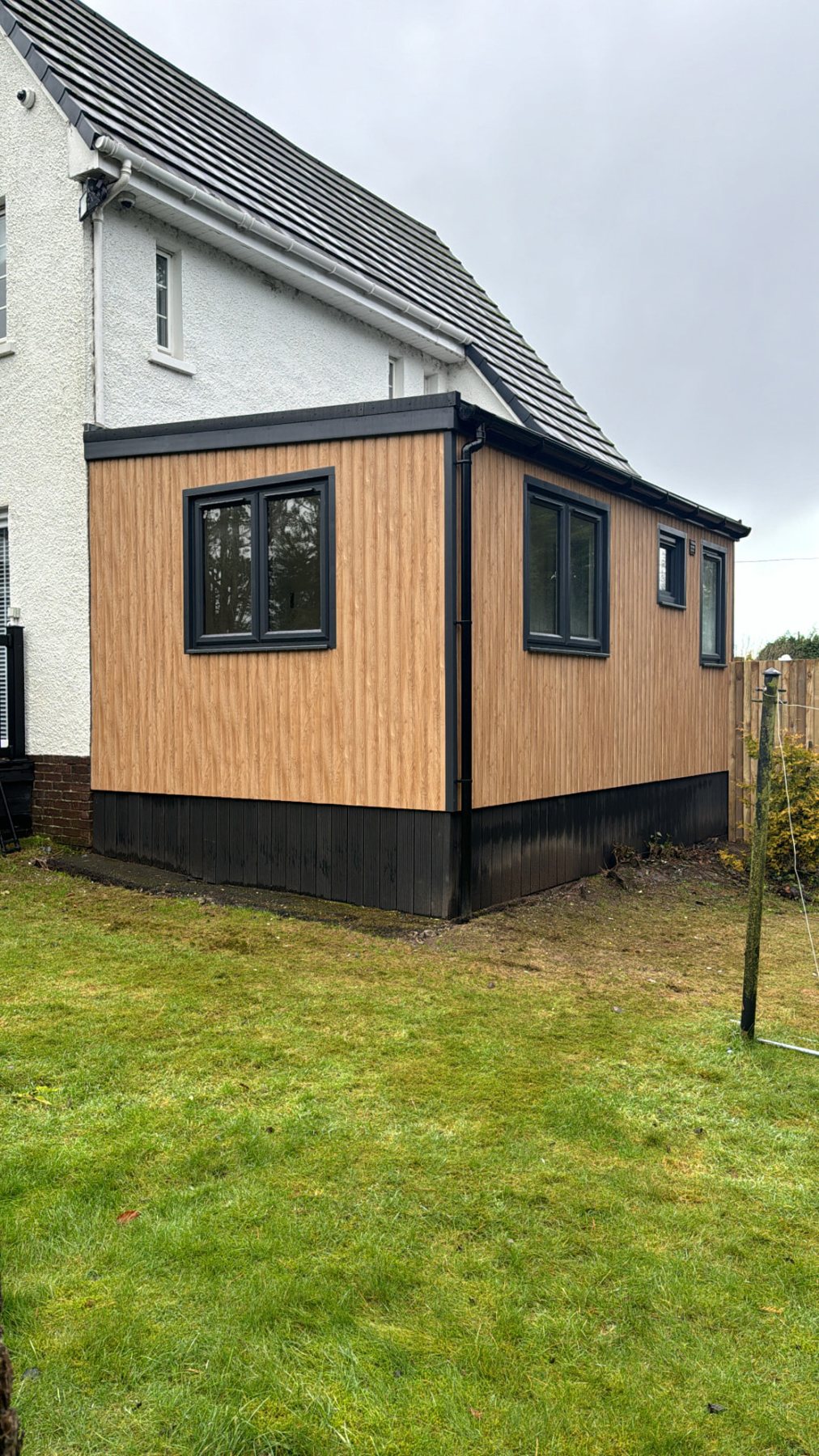 Modern timber-effect clad garden room extension attached to side of white house | Signature Garden Rooms, Central Scotland