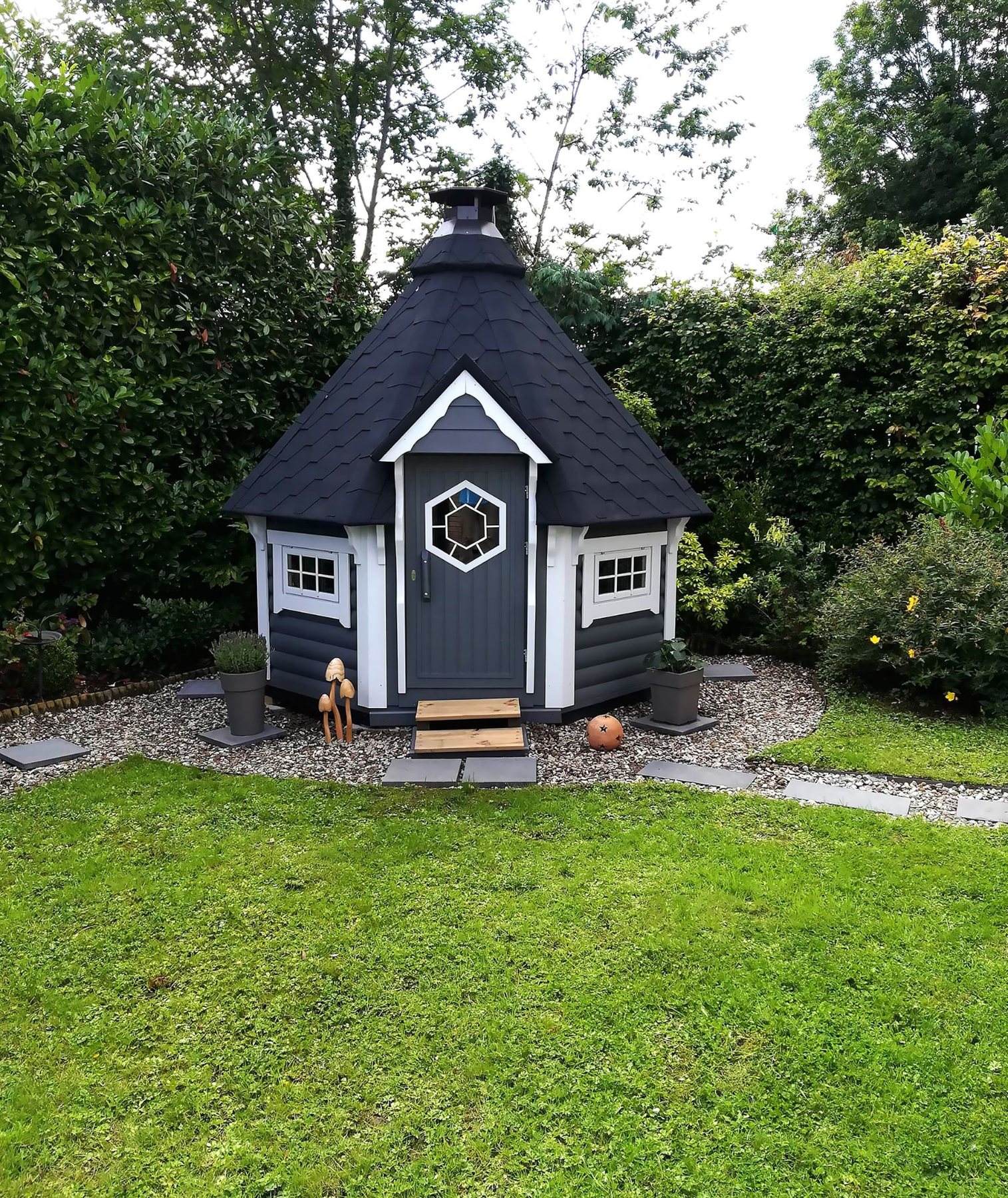 Grey painted wooden barbecue hut with white trim in a landscaped garden | Signature Garden Rooms, Central Scotland