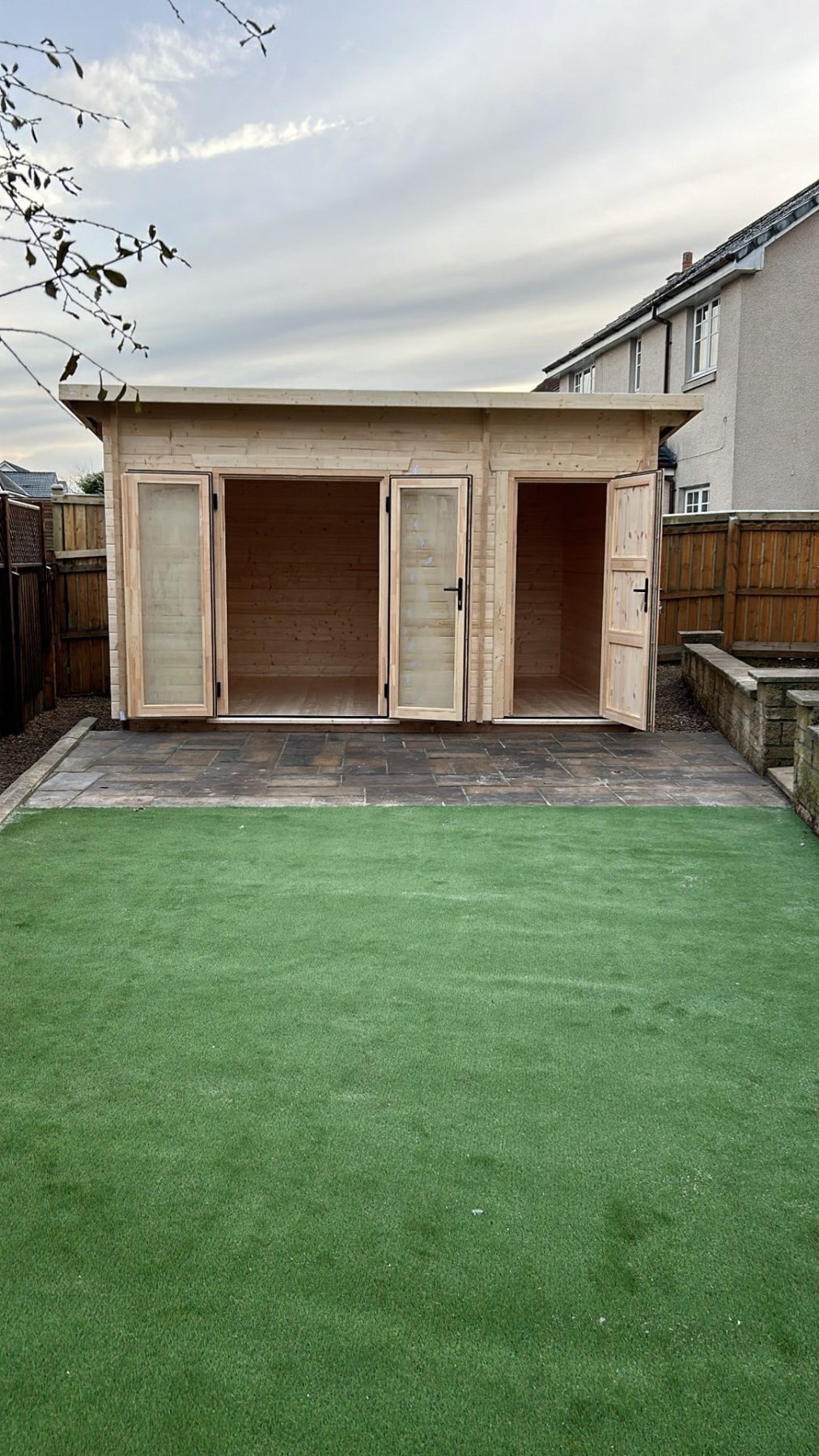 Timber pent roof log cabin with open double doors and integrated side shed | Signature Garden Rooms, Central Scotland