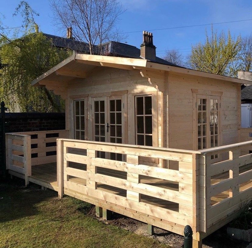 Wooden log cabin with apex roof overhang, glazed doors, and raised timber decking | Signature Garden Rooms, Central Scotland