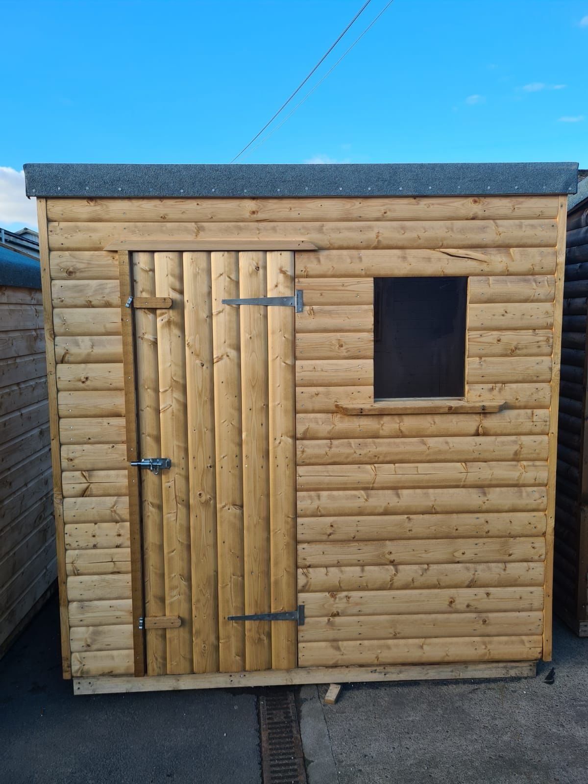 Small wooden garden shed with single timber door and small square window | Signature Garden Rooms, Central Scotland