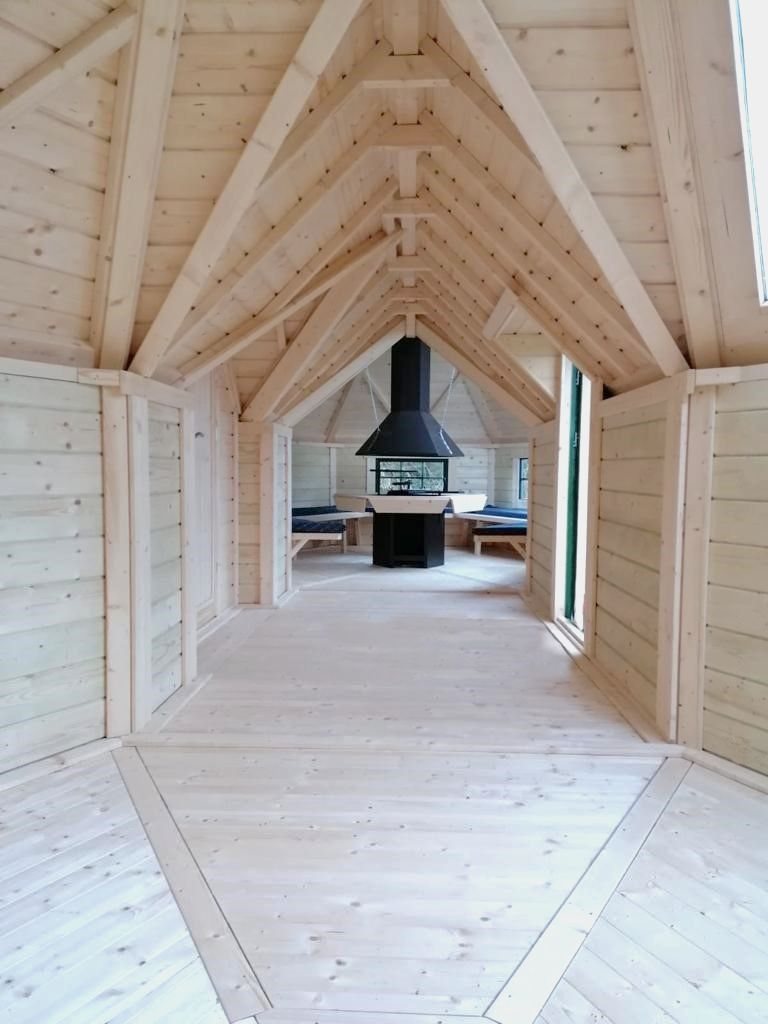 Interior view of wooden BBQ hut showing timber ceiling and central grill | Signature Garden Rooms, Central Scotland