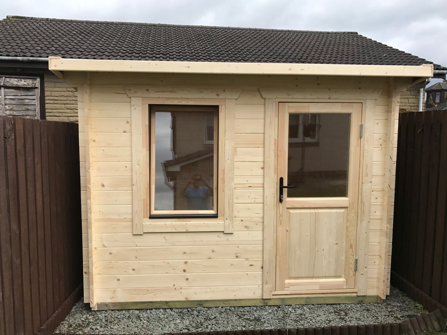 Small natural timber log cabin featuring a single glazed door and window | Signature Garden Rooms, Central Scotland