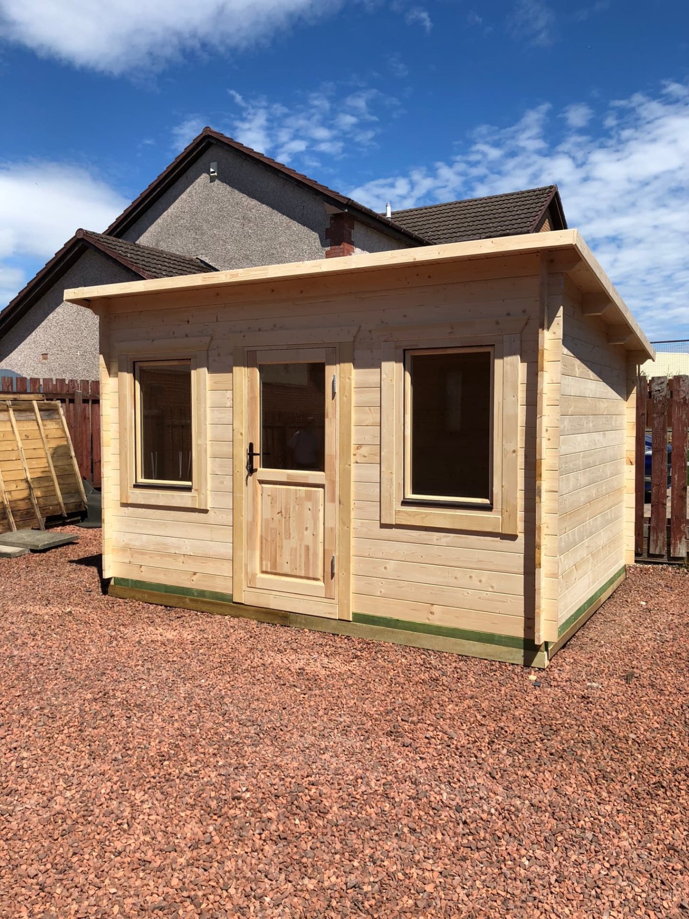 Small natural wood log cabin with a pent roof on red gravel chippings | Signature Garden Rooms, Central Scotland