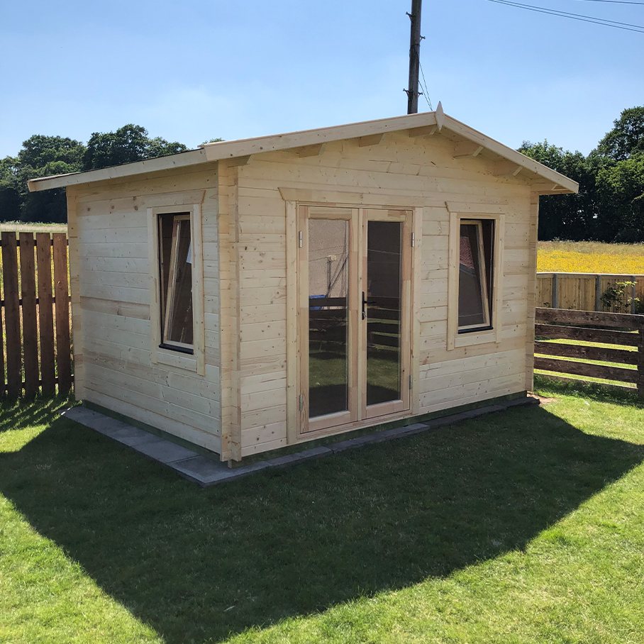 Natural timber apex roof log cabin with glazed double doors on grass | Signature Garden Rooms, Central Scotland