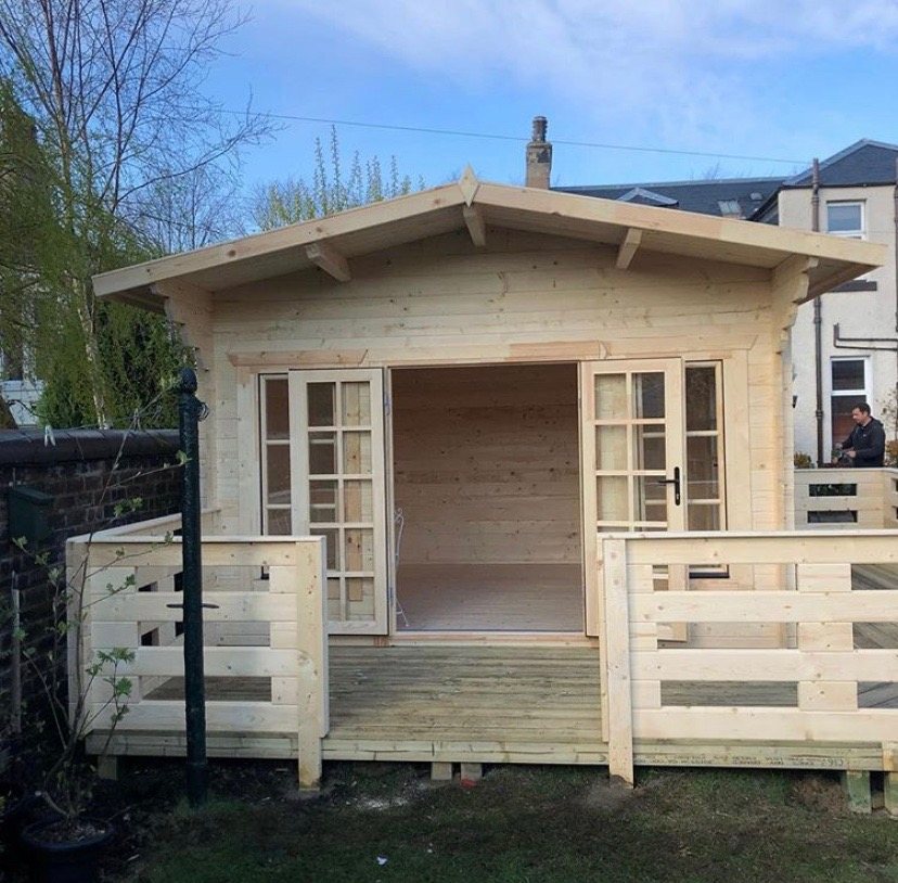 A light timber log cabin featuring open double doors and small front deck | Signature Garden Rooms, Central Scotland