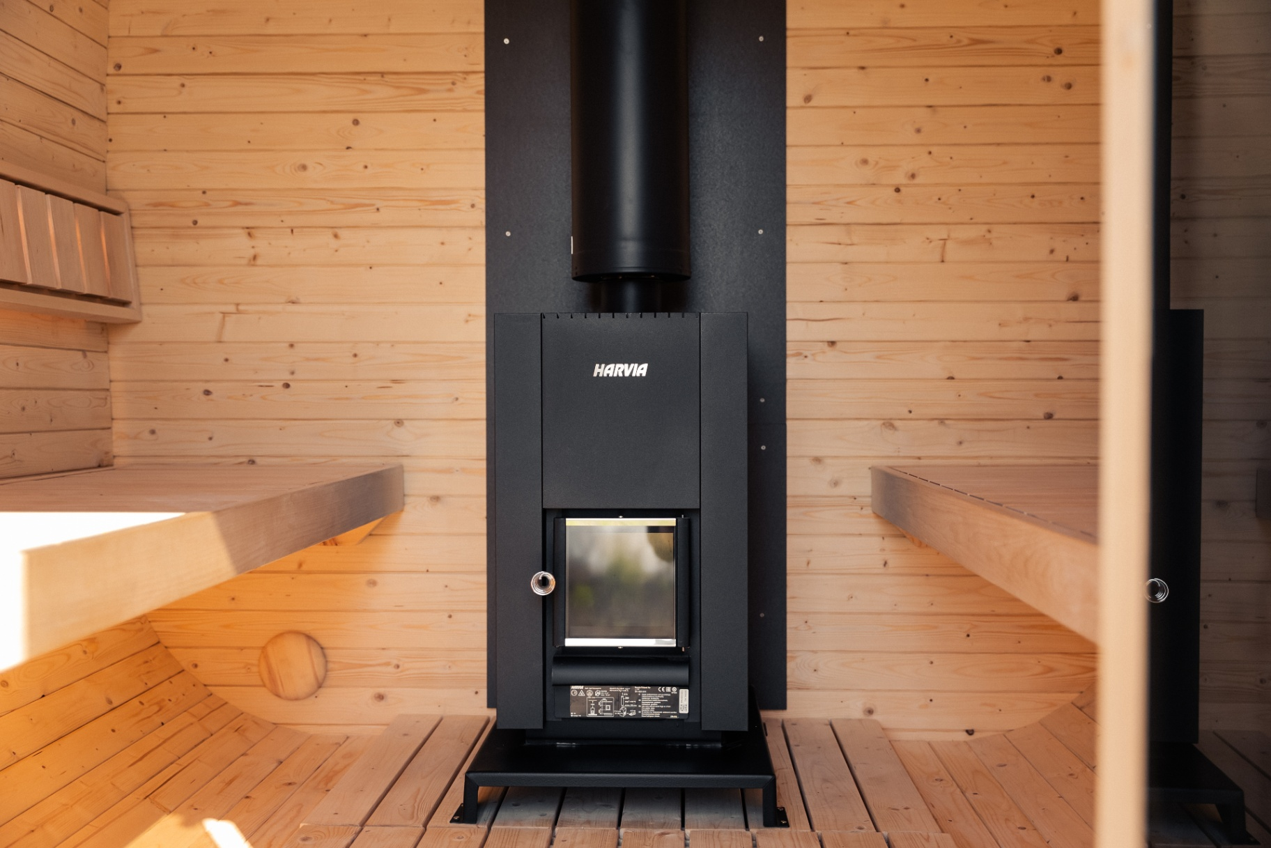 Harvia wood-burning sauna stove installed inside a cedar-clad cabin