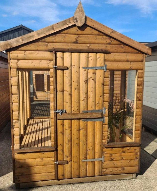 A small timber potting shed featuring large windows and a slatted interior bench | Signature Garden Rooms, Central Scotland