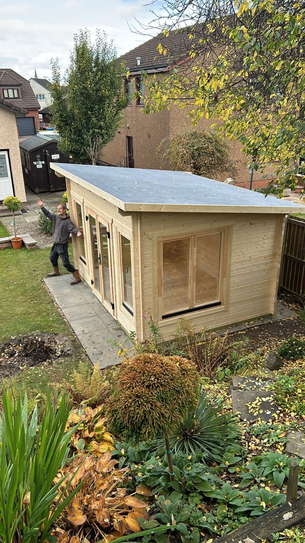 A newly installed wooden log cabin with pent roof in a residential back garden | Signature Garden Rooms, Central Scotland