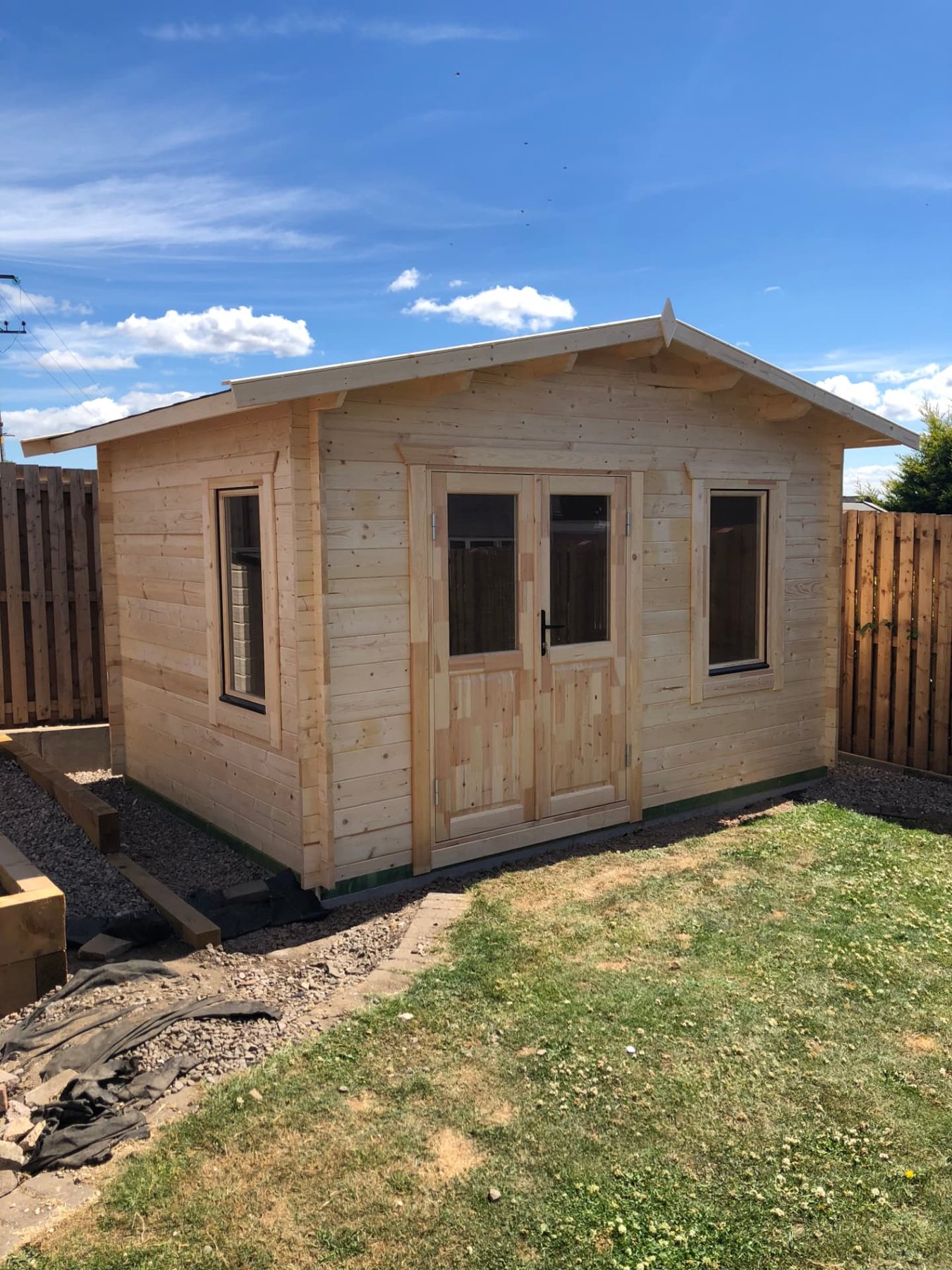 Small natural timber log cabin with double doors and windows in a garden | Signature Garden Rooms, Central Scotland