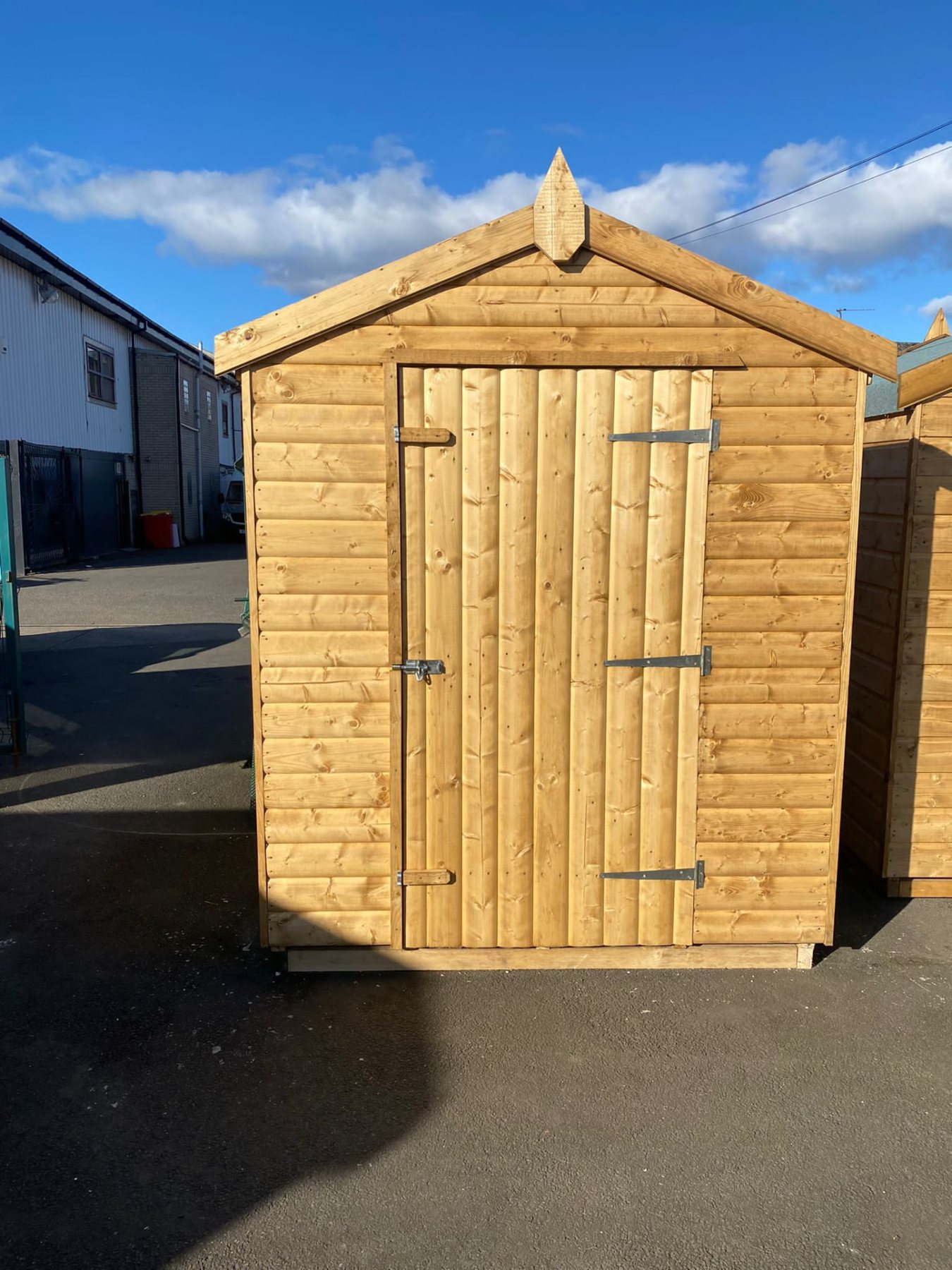 Apex wooden garden shed with single central door in an outdoor display yard | Signature Garden Rooms, Central Scotland