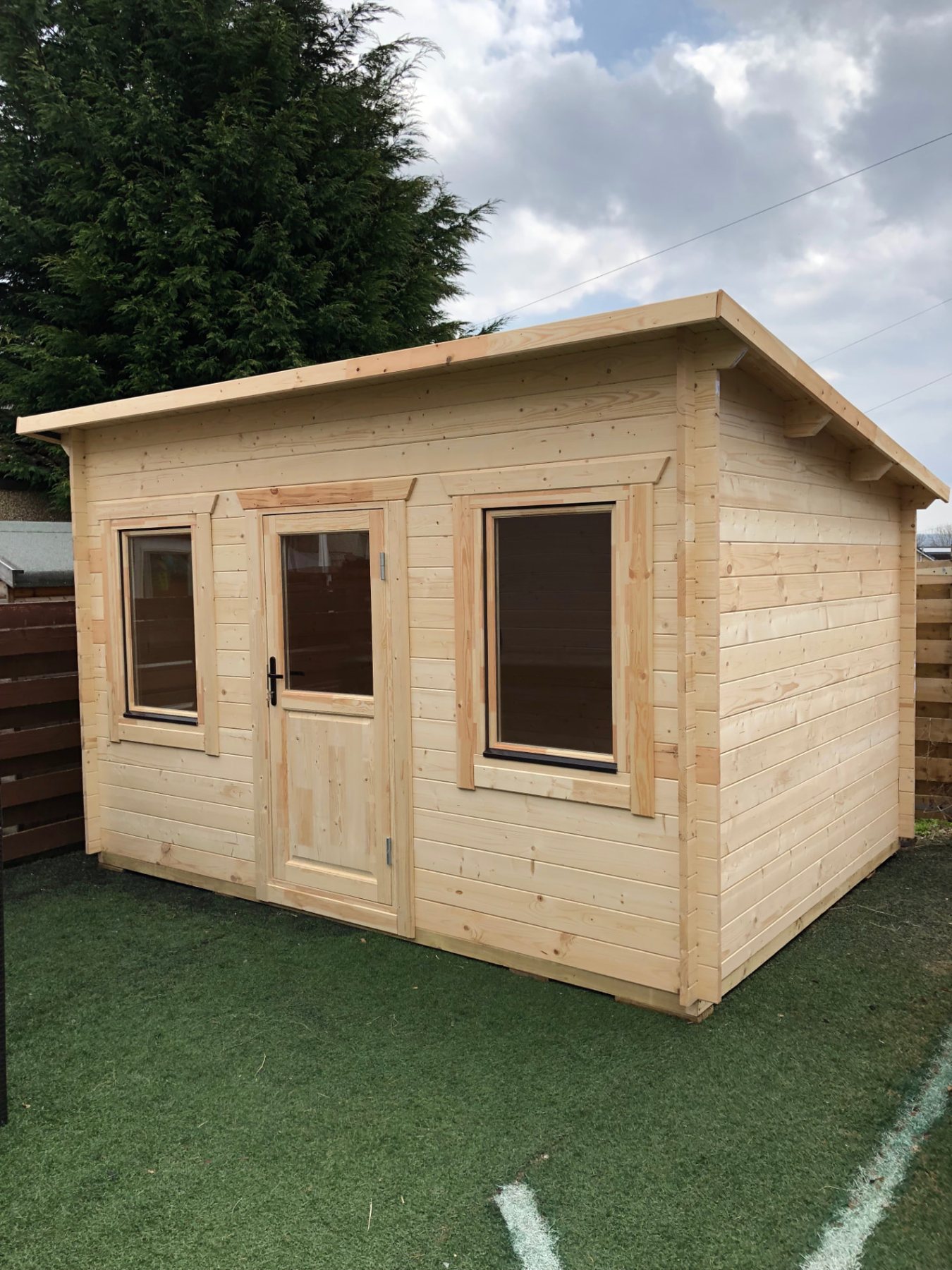 Light timber log cabin with pent roof, glazed door, and two windows | Signature Garden Rooms, Central Scotland