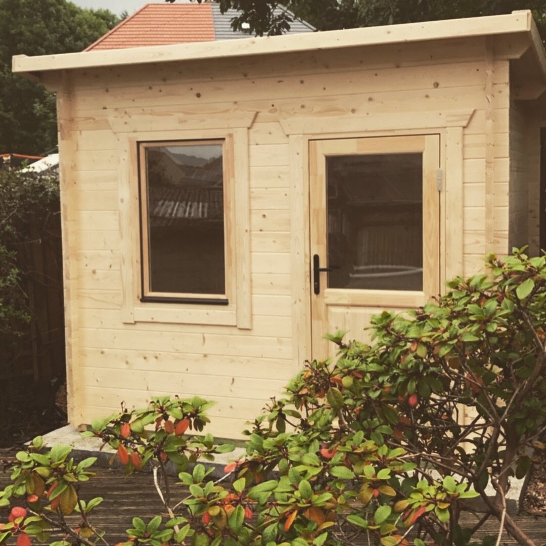 Small light timber log cabin with pent roof, single window, and glazed door | Signature Garden Rooms, Central Scotland