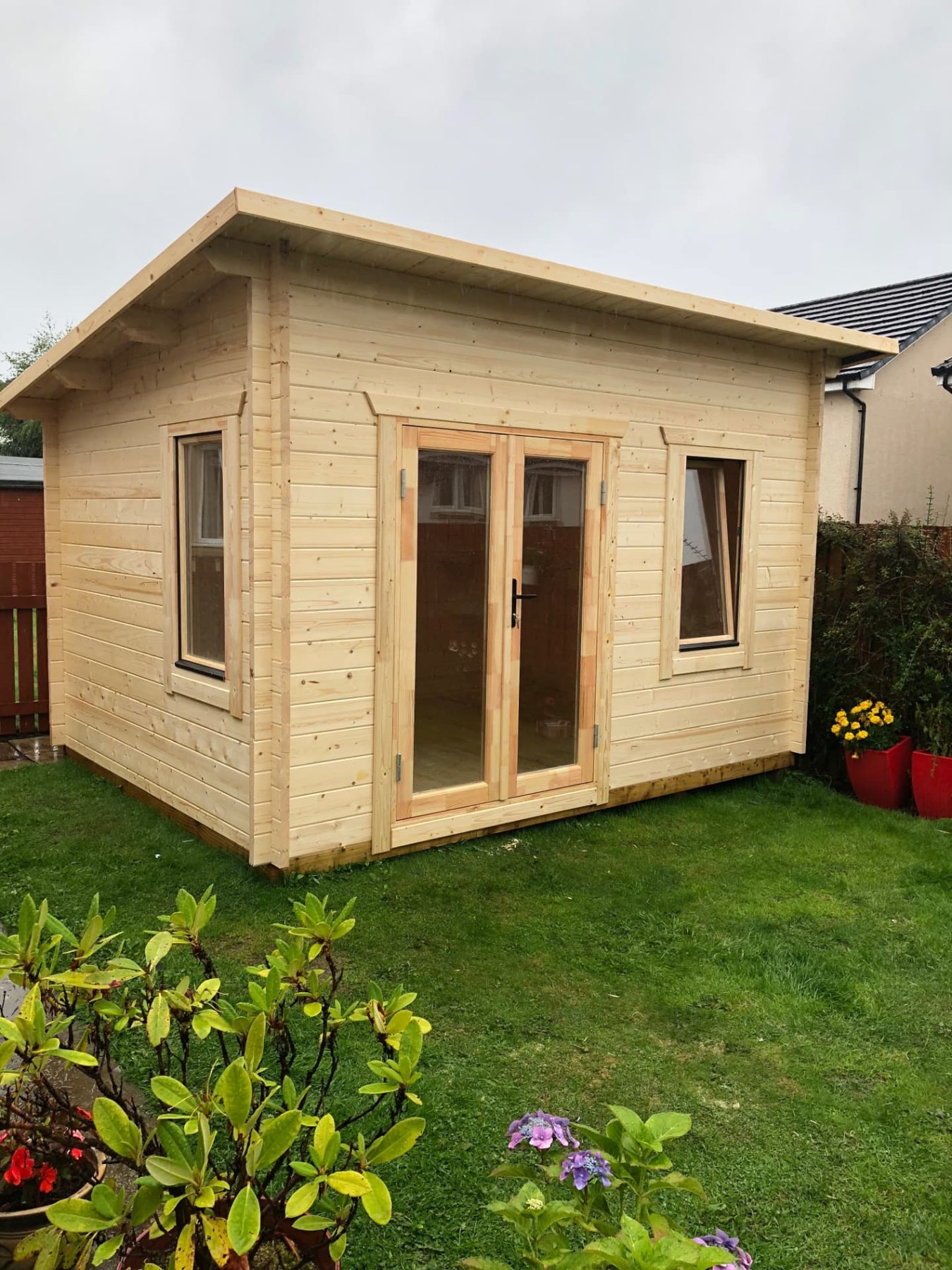 Light timber log cabin with pent roof and double glass doors in garden | Signature Garden Rooms, Central Scotland