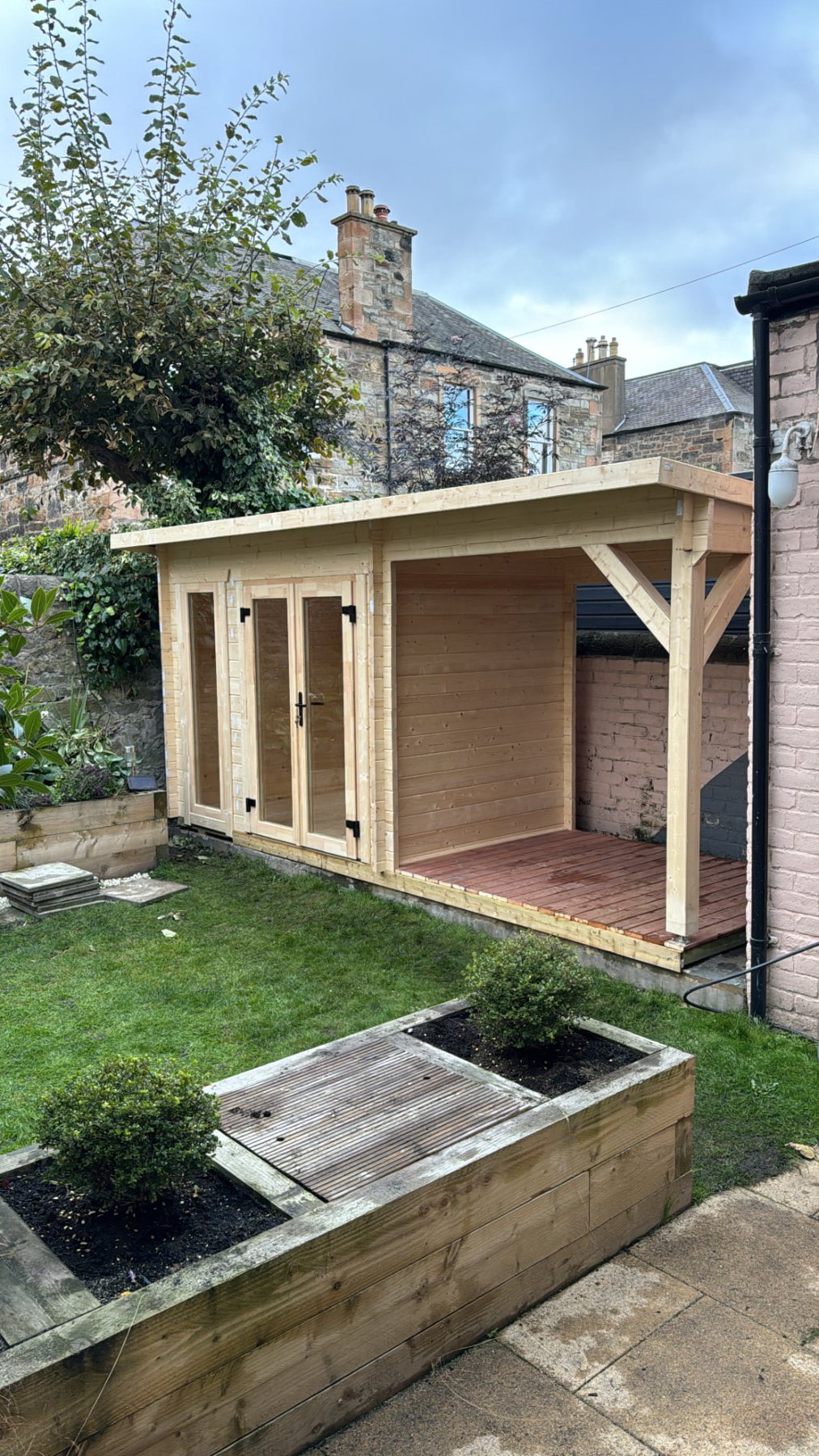 Light timber log cabin with glass double doors and an attached side canopy | Signature Garden Rooms, Central Scotland