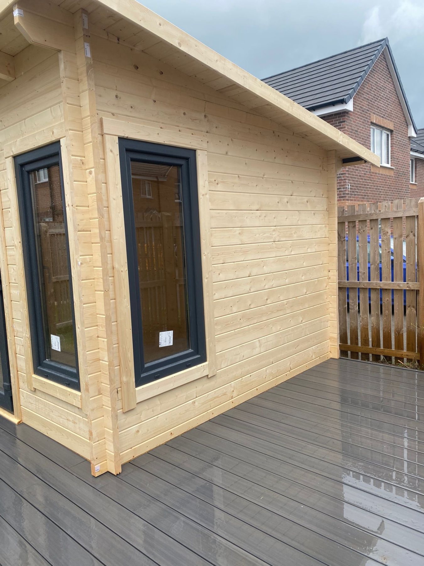 Timber log cabin featuring dark grey uPVC windows set on wet composite decking | Signature Garden Rooms, Central Scotland