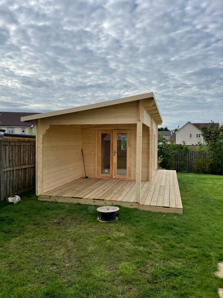 A natural wood log cabin featuring a covered veranda and wooden decking | Signature Garden Rooms, Central Scotland