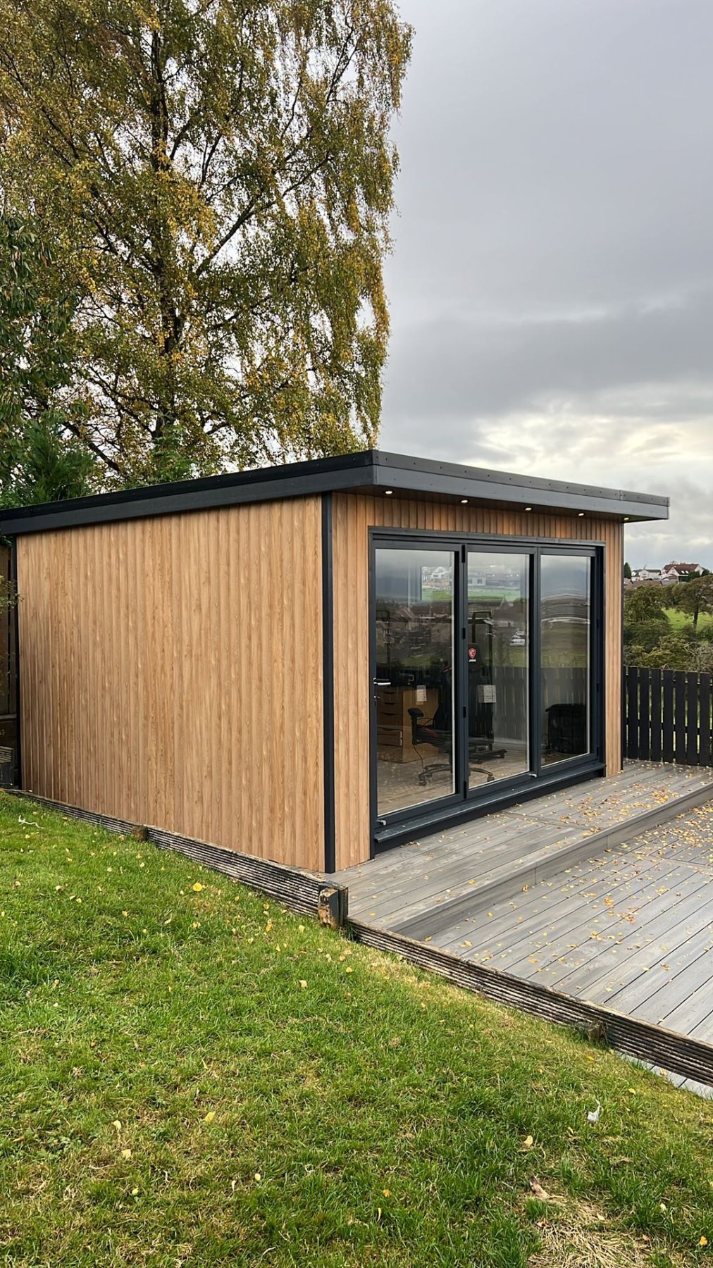 Modern timber clad garden room with glass sliding doors and front decking | Signature Garden Rooms, Central Scotland