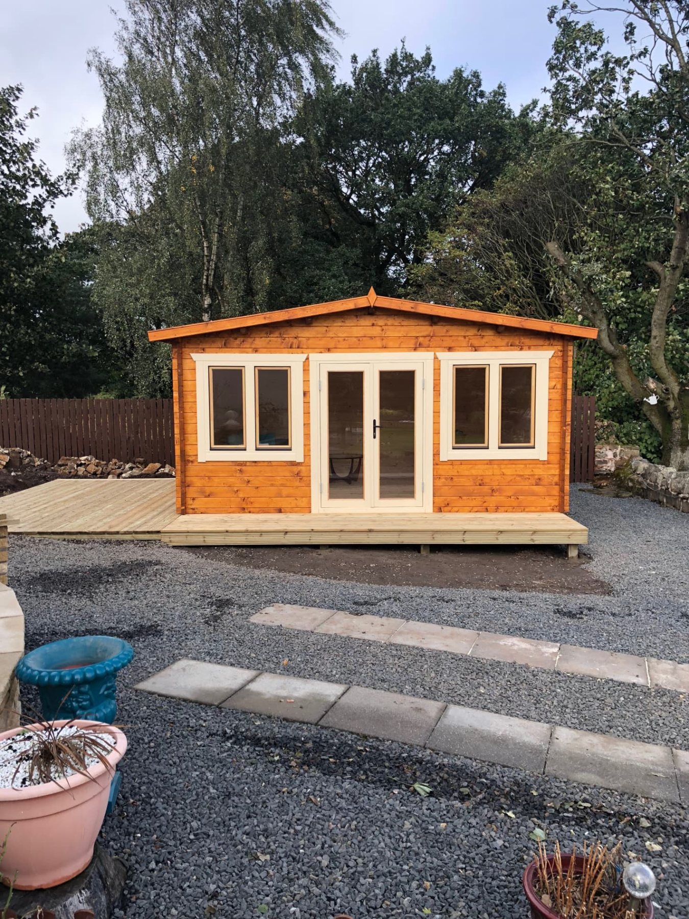 Apex roof timber log cabin with cream double doors and matching side windows | Signature Garden Rooms, Central Scotland