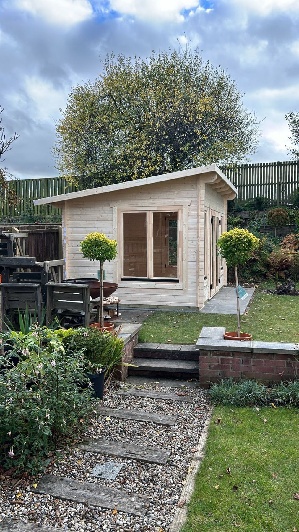 Light timber log cabin with pent roof in a landscaped garden context | Signature Garden Rooms, Central Scotland