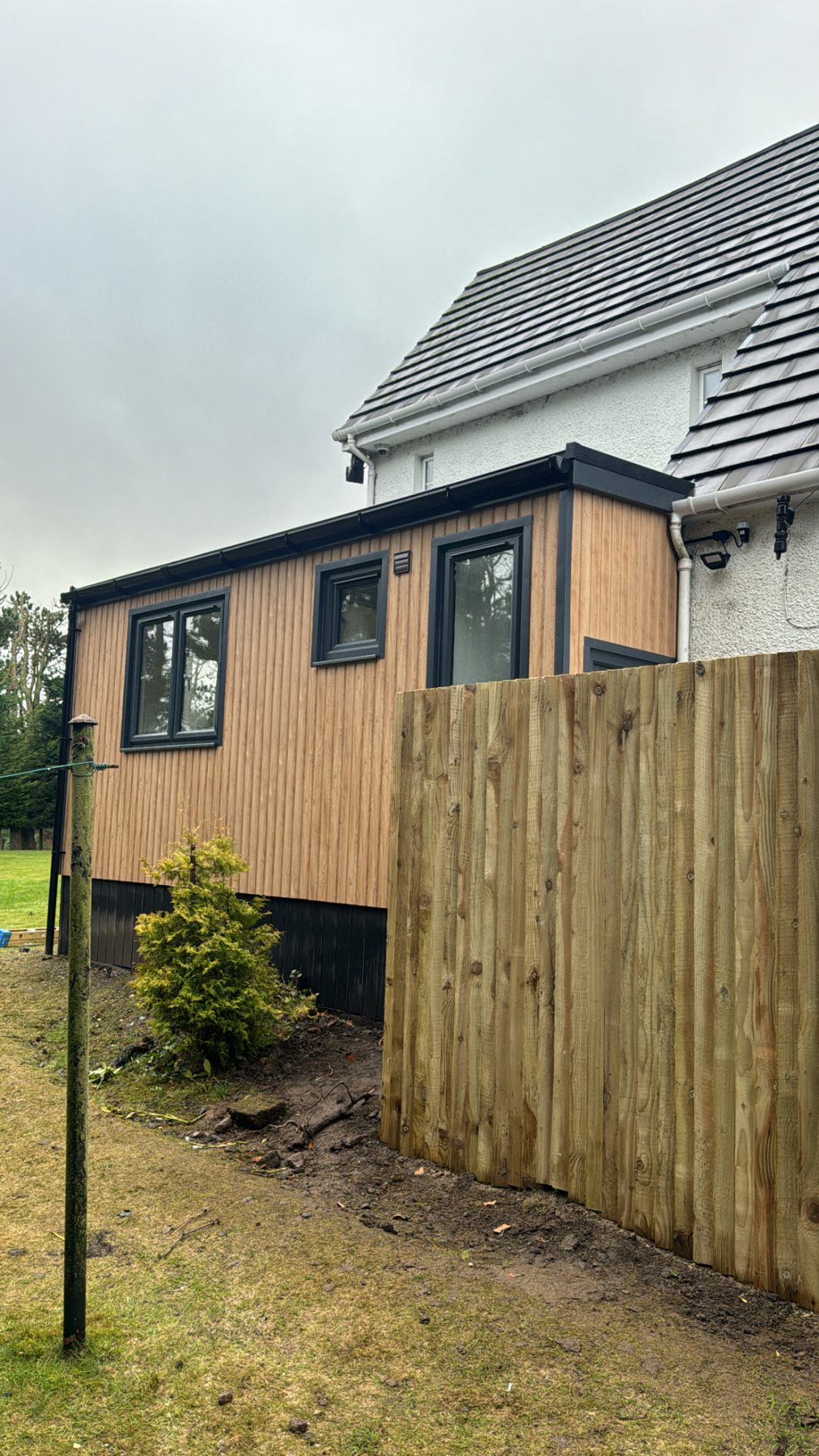 Timber clad modern garden room extension attached to white two storey house | Signature Garden Rooms, Central Scotland