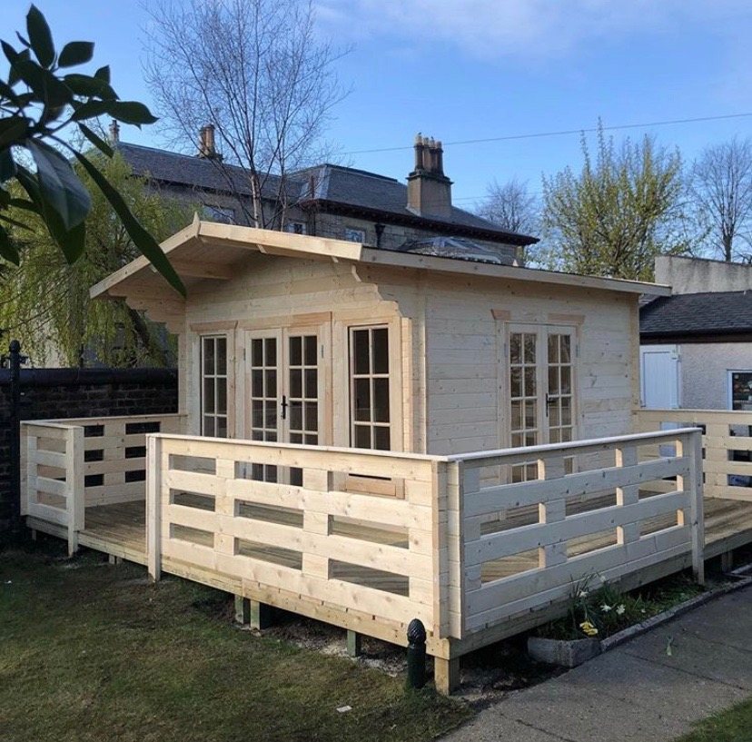 Light timber log cabin featuring a wooden deck with balustrades and glazed double doors | Signature Garden Rooms, Central Scotland