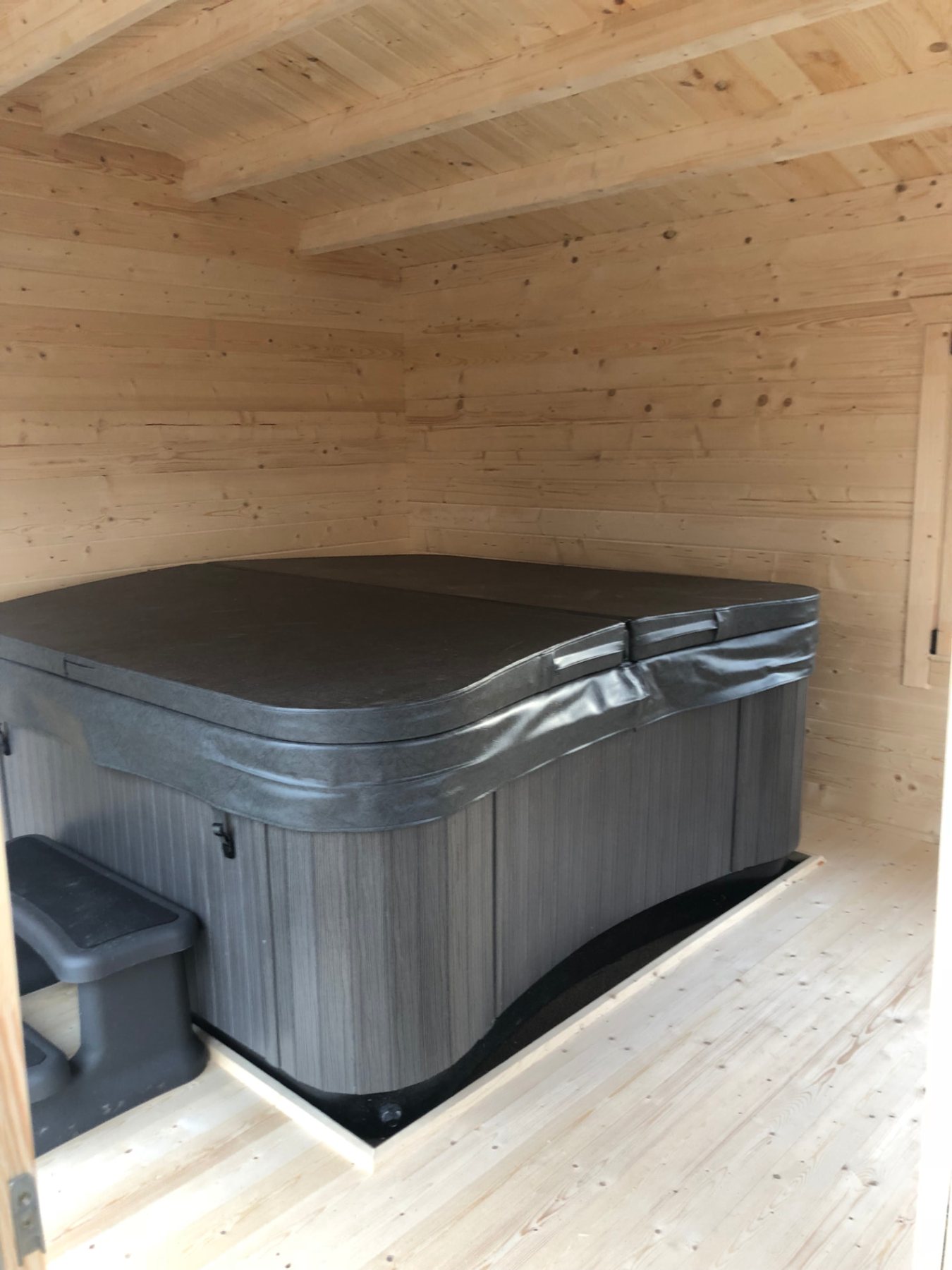 Interior view of a covered hot tub installed inside a wooden log cabin | Signature Garden Rooms, Central Scotland