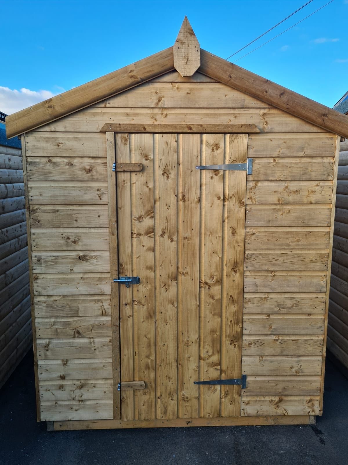 Front view of a simple wooden apex garden shed with a single door | Signature Garden Rooms, Central Scotland