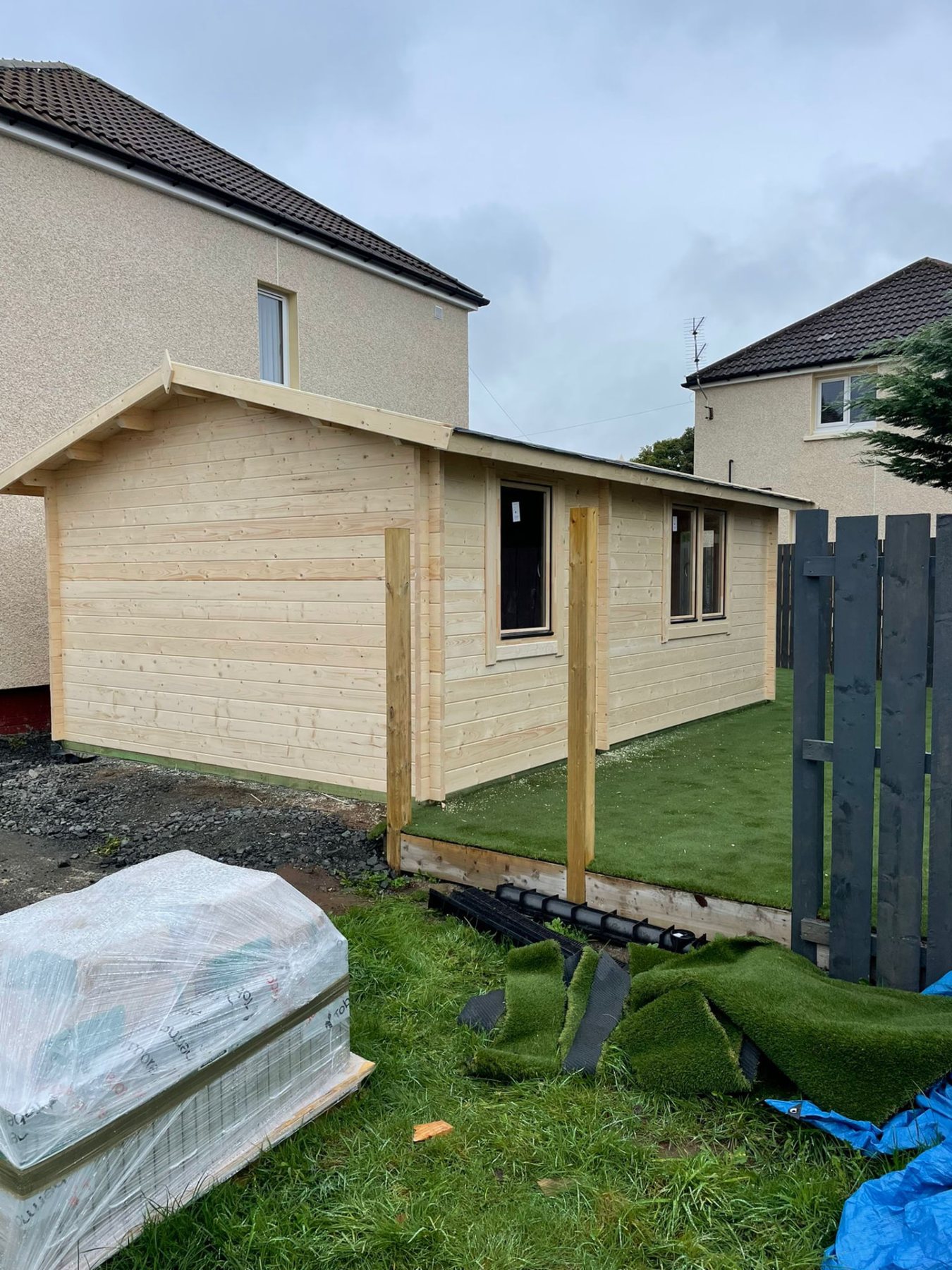 Newly assembled light timber log cabin with apex roof in a residential garden | Signature Garden Rooms, Central Scotland