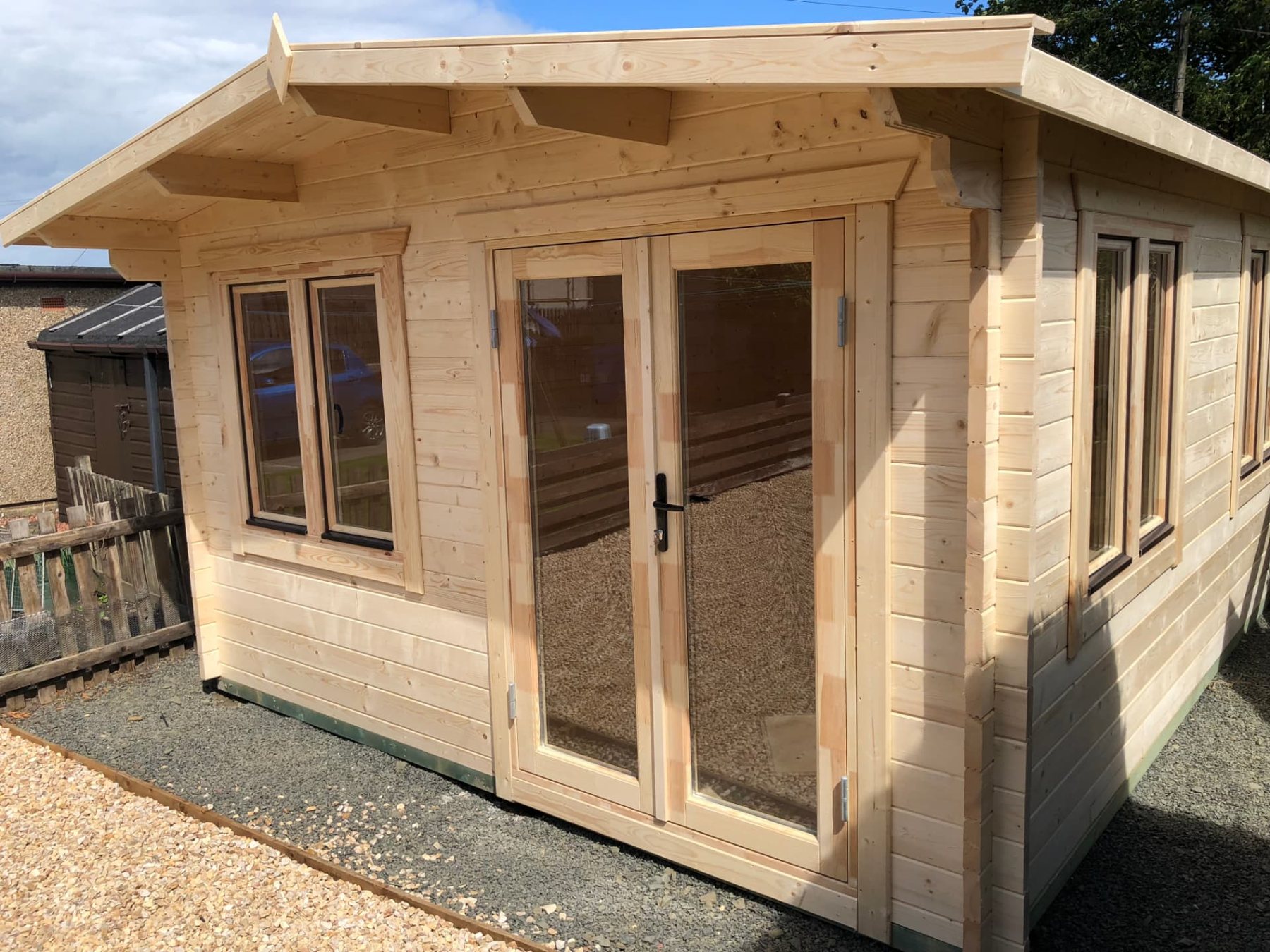 Natural light timber log cabin featuring double glass doors and side windows | Signature Garden Rooms, Central Scotland