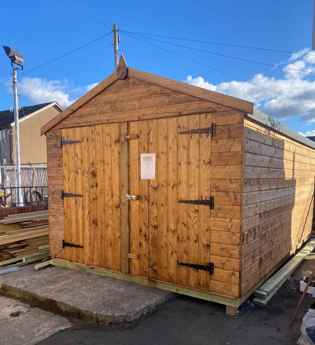 A large wooden apex garden shed with double doors displayed outdoors | Signature Garden Rooms, Central Scotland