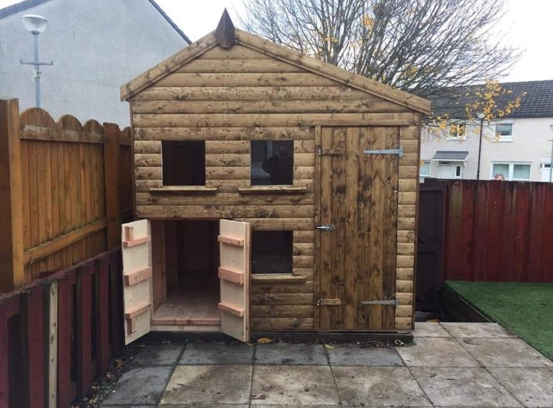 Apex timber playhouse with lower double hatch doors on paved patio | Signature Garden Rooms, Central Scotland