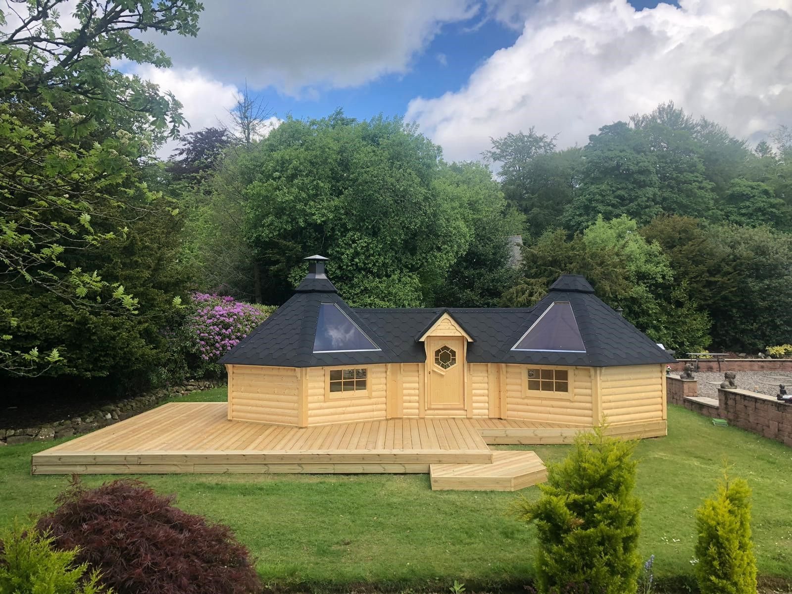 Large timber double BBQ hut with central door on raised wooden decking | Signature Garden Rooms, Central Scotland
