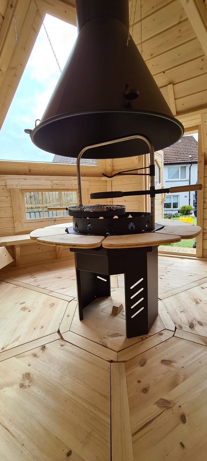 Central metal grill and flue system inside a wooden BBQ hut interior | Signature Garden Rooms, Central Scotland