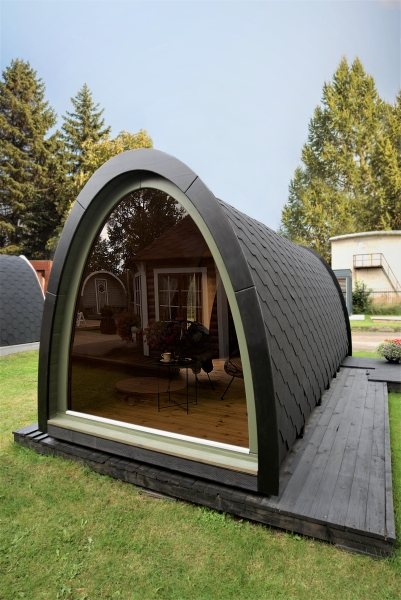 Modern arched glamping pod with large glass window on timber decking outdoors | Signature Garden Rooms, Central Scotland
