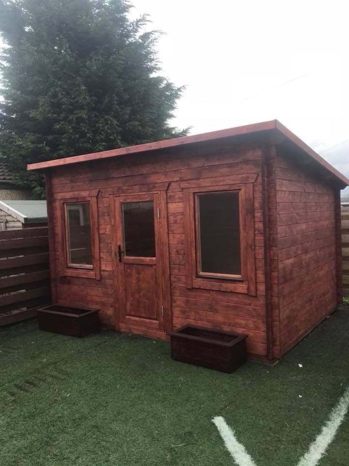 Red-brown stained pent log cabin with central glazed door and two side windows | Signature Garden Rooms, Central Scotland