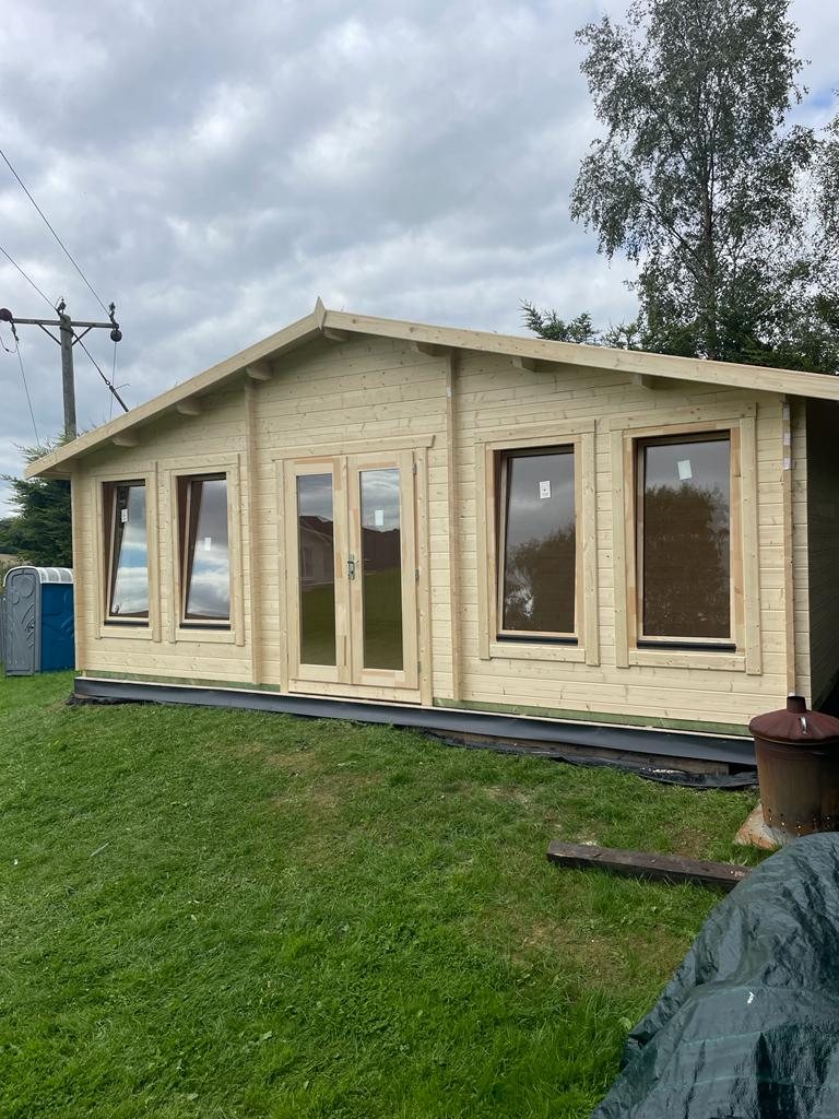 Large light timber log cabin featuring an apex roof double doors and four windows | Signature Garden Rooms, Central Scotland