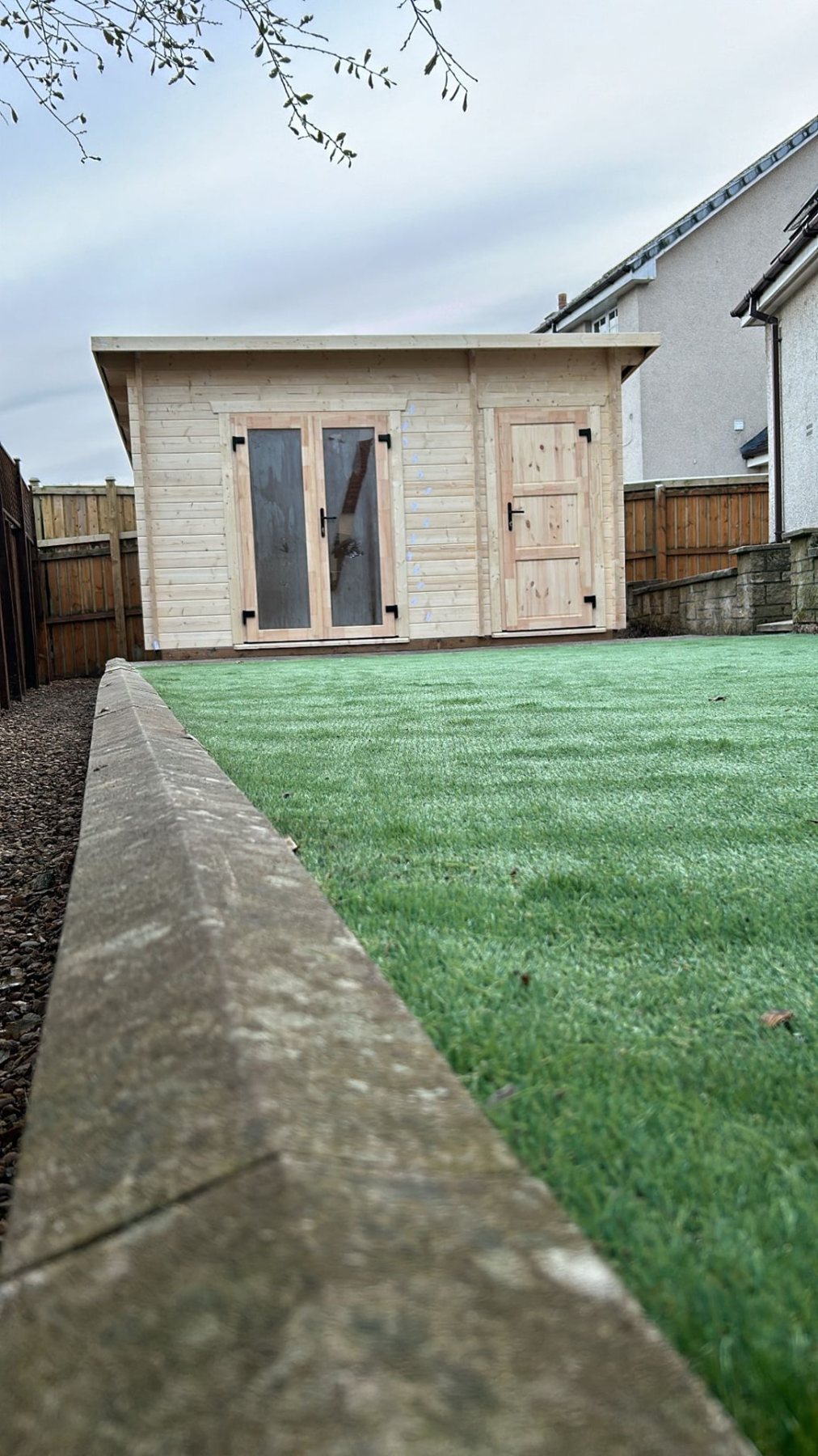 Light timber log cabin with double glazed doors and integrated side storage shed | Signature Garden Rooms, Central Scotland
