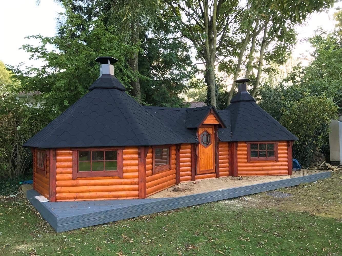 Large double timber BBQ hut with twin chimneys set on grey decking | Signature Garden Rooms, Central Scotland