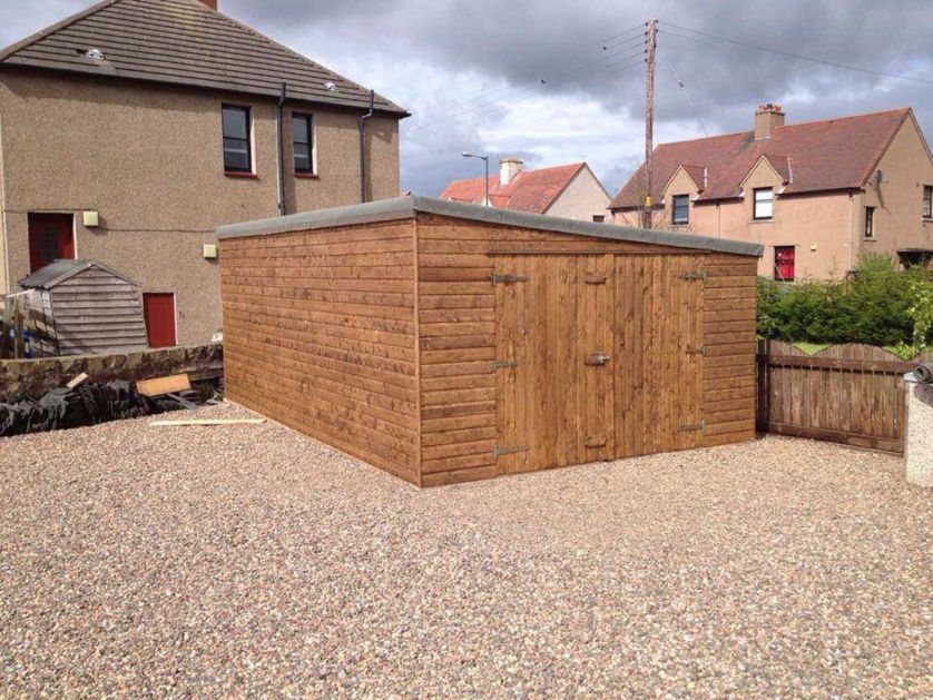 Large timber garage with pent roof situated on a gravel driveway | Signature Garden Rooms, Central Scotland
