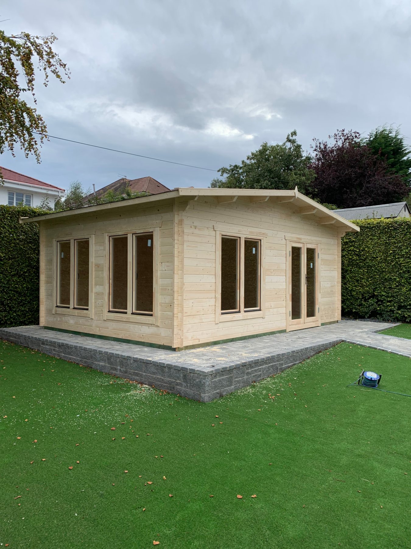 Large light timber log cabin with glass double doors on paved base | Signature Garden Rooms, Central Scotland