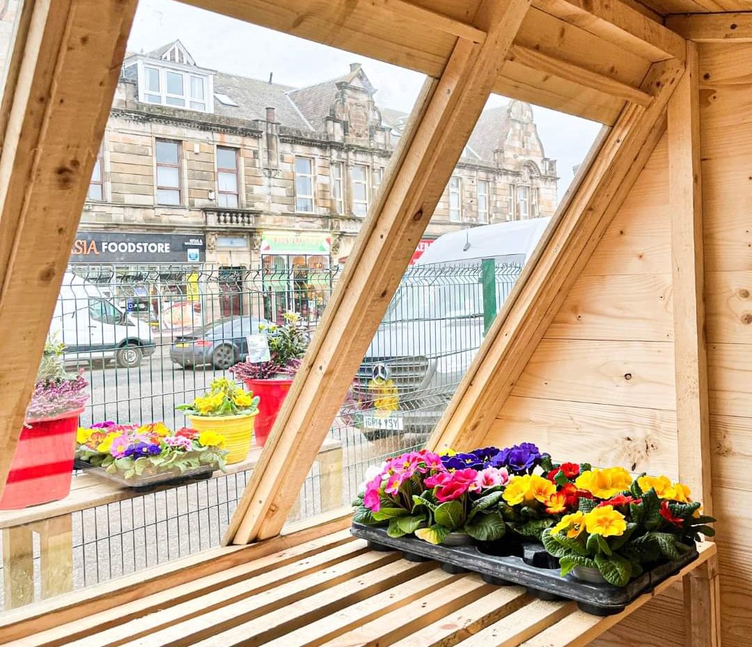 Interior view of a wooden potting shed featuring sloped windows and potted flowers | Signature Garden Rooms, Central Scotland